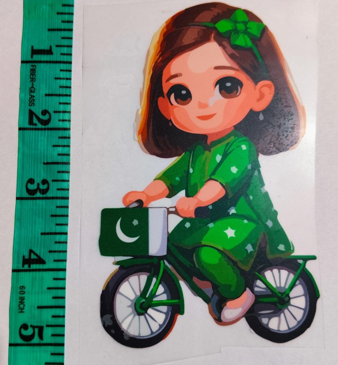Front view of Doll on Bicycle iron-on patch – playful embroidered design for kidswear from HnA Boutique Pakistan