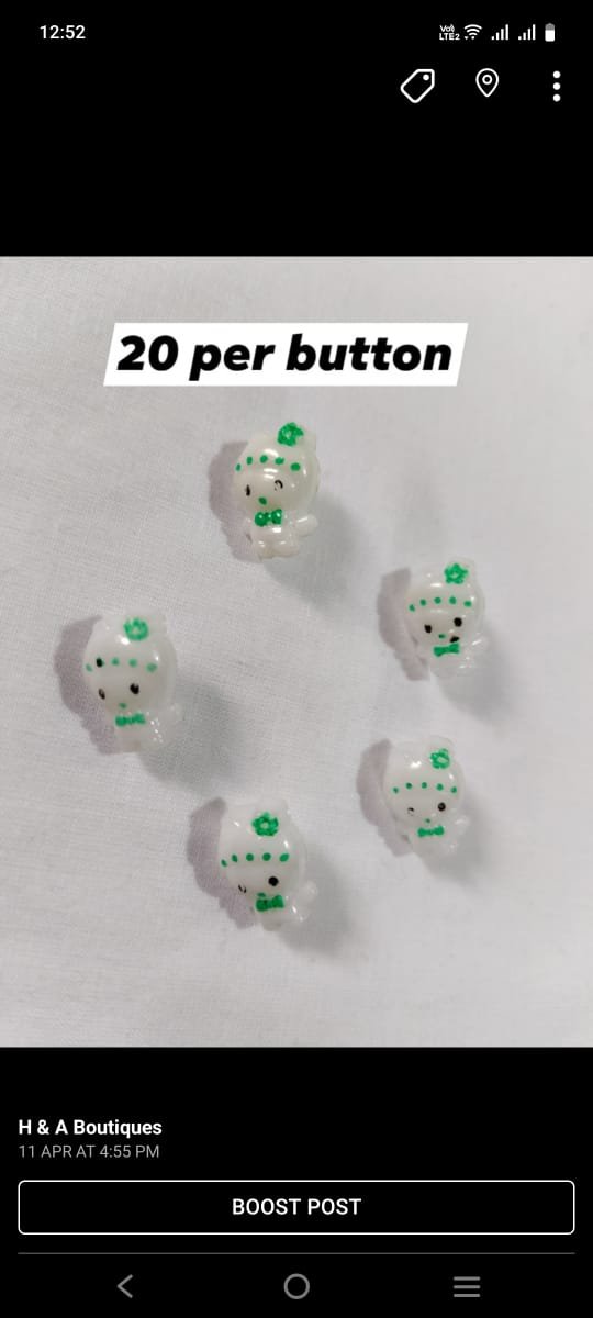 Close-up of Azadi Mini Dolls Buttons in green and white – HnA Boutique Pakistan