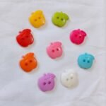 Mini Apples Multi Buttons showing colorful apple designs – funky buttons by HnA Boutique Pakistan