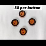 Orange & Black funky buttons close-up showing bold color combo – HnA Boutique Pakistan