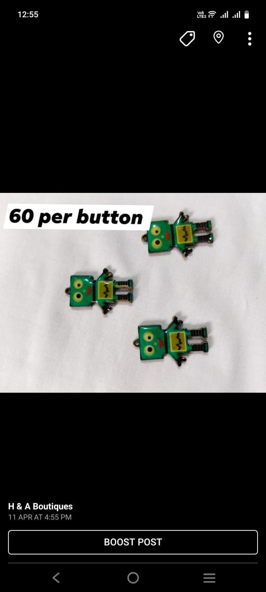 Close-up of metallic Robot Buttons with quirky design – HnA Boutique Pakistan