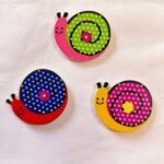 Close-up view of wooden Snail Buttons with carved design – HnA Boutique Pakistan