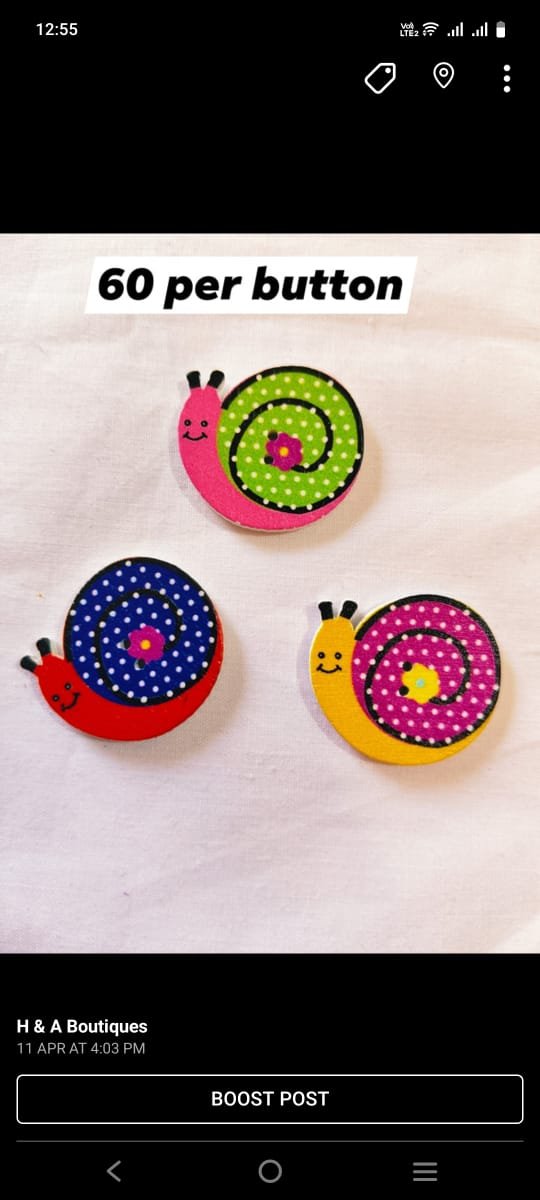Close-up view of wooden Snail Buttons with carved design – HnA Boutique Pakistan