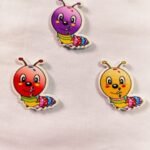 Close-up of Caterpillar 1 wooden buttons with detailed design – HnA Boutique Pakistan