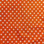 Orange polka lawn fabric with white dots – breathable and trendy for summer wear in Pakistan