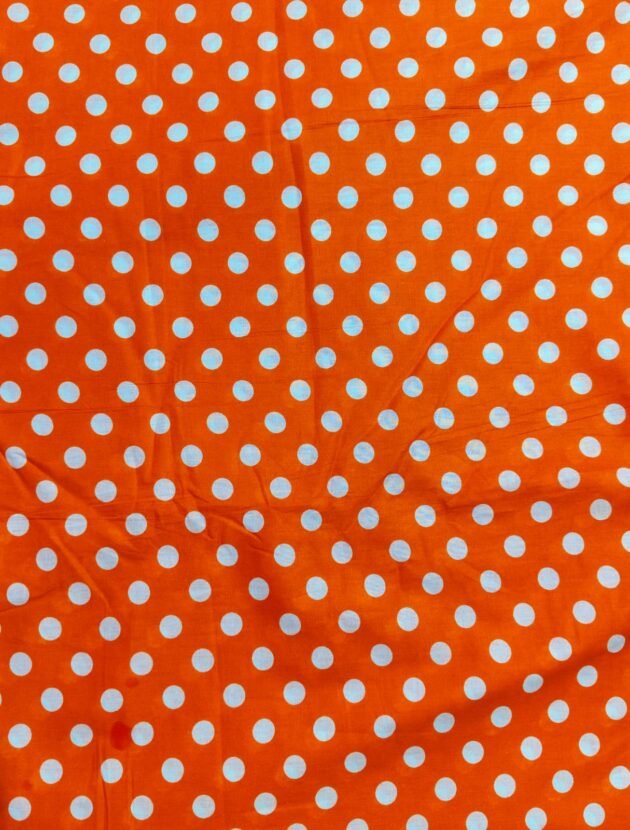 Orange polka lawn fabric with white dots – breathable and trendy for summer wear in Pakistan