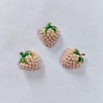 Close-up of Off White Metal Strawberry Button with fruit design – HnA Boutique Pakistan
