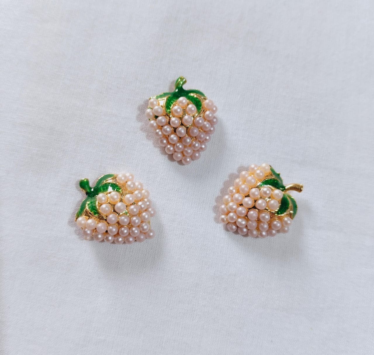 Close-up of Off White Metal Strawberry Button with fruit design – HnA Boutique Pakistan