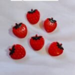 Close-up of Red Strawberry Buttons with vibrant design – HnA Boutique Pakistan