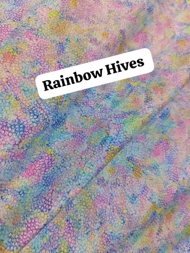Pastel rainbow honeycomb printed lawn fabric in soft hues of blue, pink, yellow, and purple – 45” width