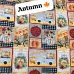 Autumn themed printed lawn fabric with pumpkins, trucks, flowers, apple cider signs, and fall phrases in warm rustic tones – 45” width